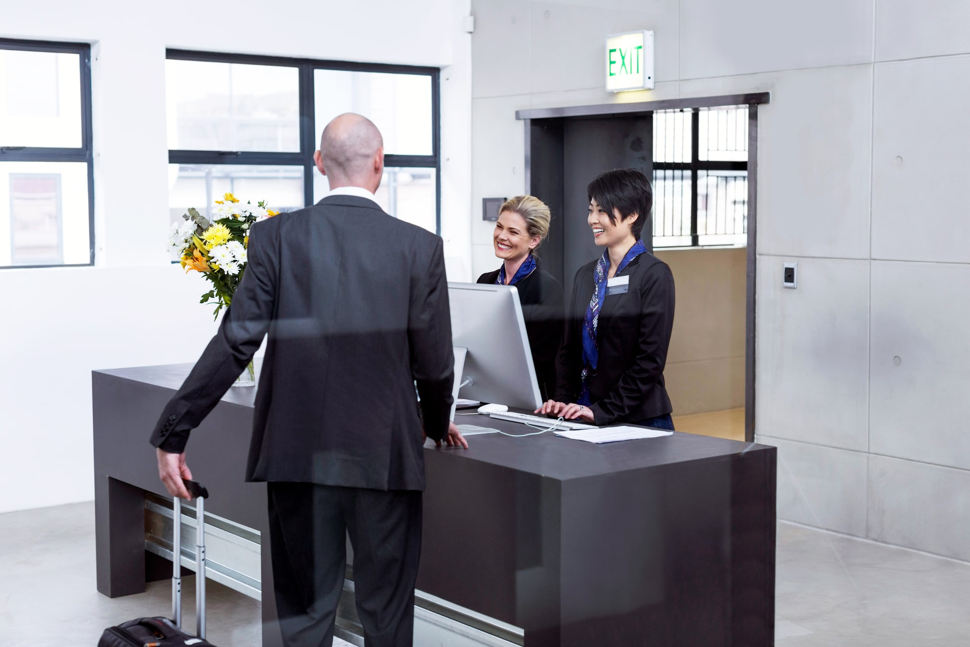 GE_Industries_Hospitality_two-women-behind-reception-desk-in-hotel-lobby-hel-2022-12-16-22-44-21-utc-min