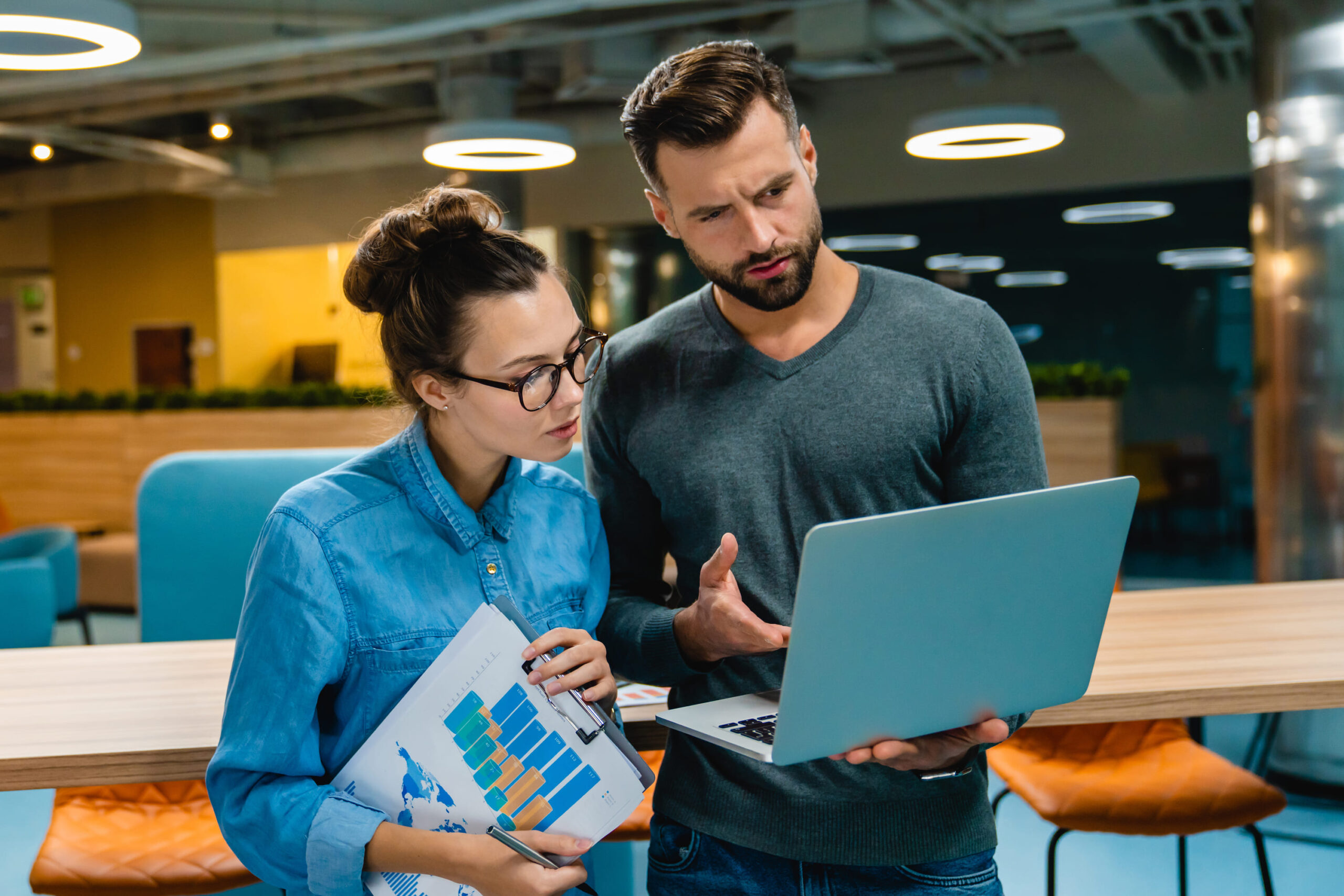 two-helpful-young-colleagues-talking-using-laptop-2023-11-27-05-04-01-utc (1)